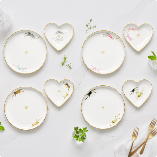 Elegant round and heart shaped plates on marble countertop